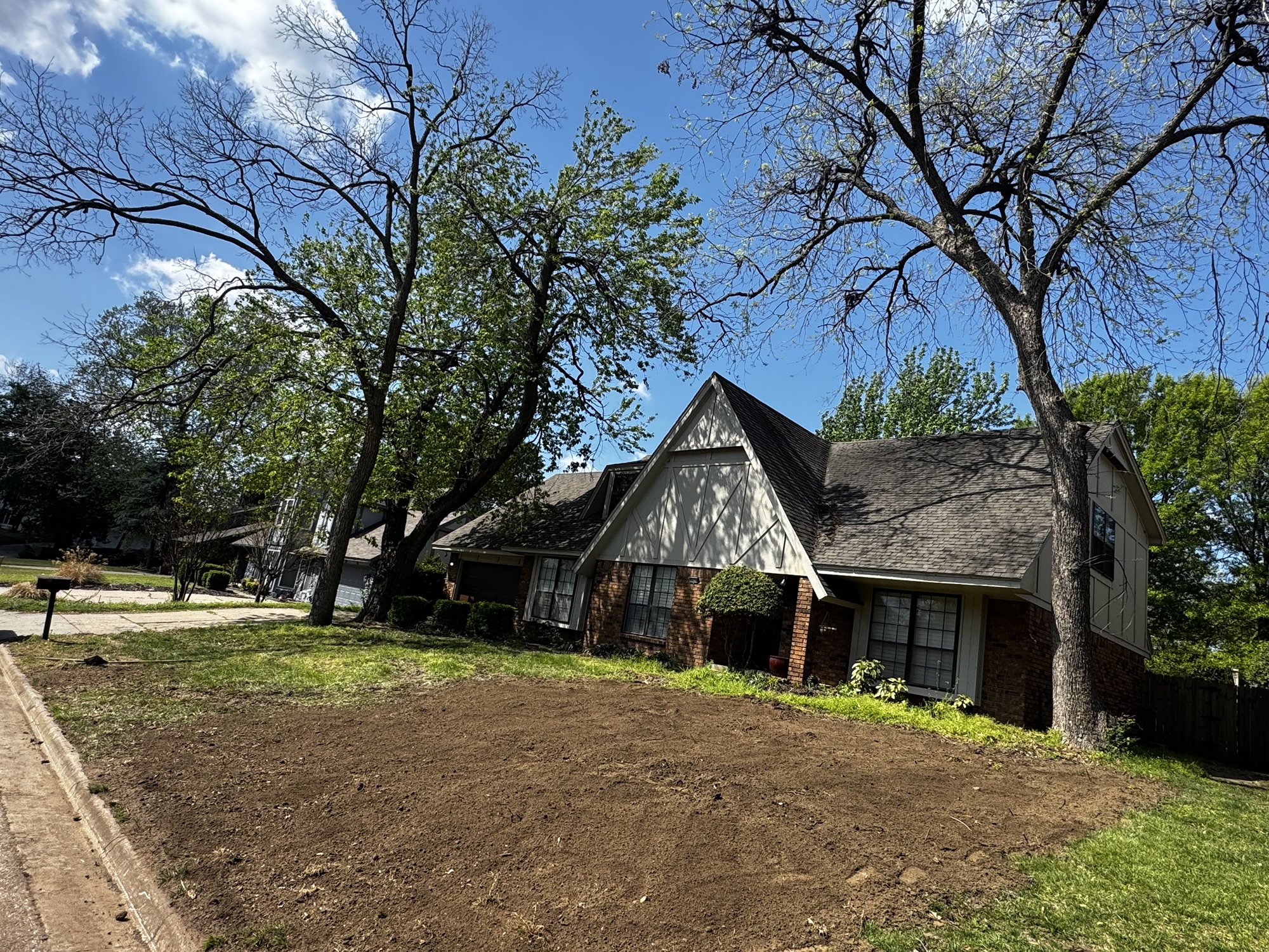 After — tree fully removed, ground graded, topsoil laid on Tulsa, Oklahoma property