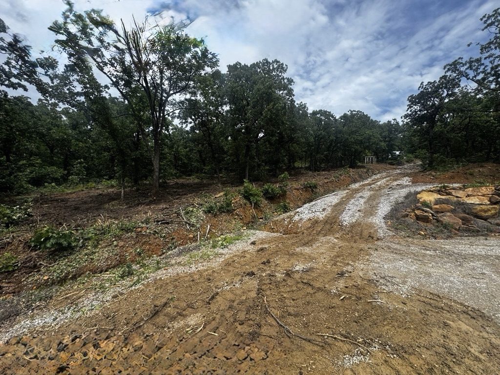 After — right of way / utility easement forestry mulching in Tulsa, Oklahoma: wide cleared corridor through wooded property