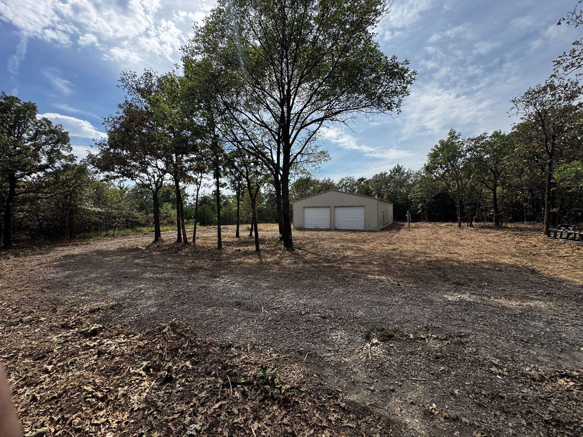 Open, mulched ground with mature oaks left standing after forestry mulching and dead fall removal in Sand Springs, Tulsa County, Oklahoma